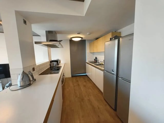 Modern kitchen with fridge kettle stove and cabinets kitchen at London court in Sheffield Student Accommodation