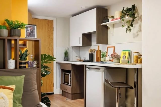 Modern kitchen with microwave fridge and bar stool kitchen at Sugarhouse in Edinburgh Student Accommodation