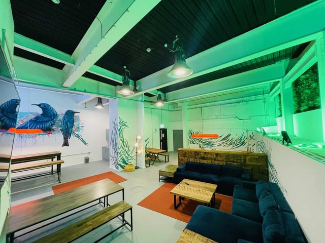 Seating tables couches and murals common area at The Nest in Nottingham Student Accommodation