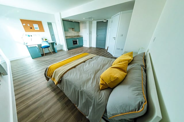 Bed desk kitchenette and corkboard study area at The Nest in Nottingham Student Accommodation