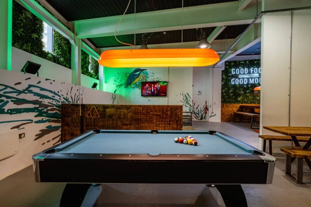 Pool table with balls and cues playing area at The Nest in Nottingham Student Accommodation