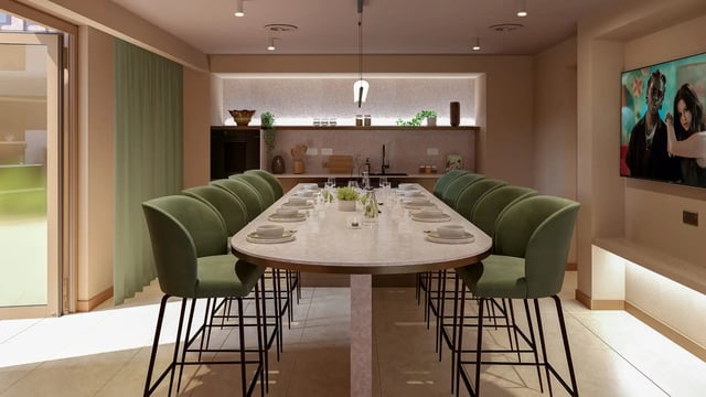 Dining table with green chairs and kitchen area Dining area at Threadworks in Leeds Student Accommodation