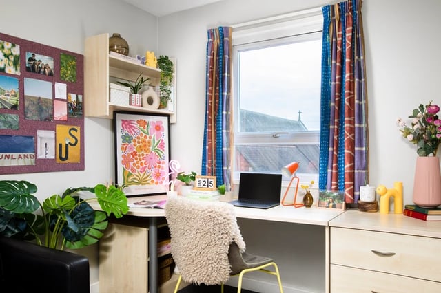 Desk with laptop plants and corkboard study area at Raglan House in Coventry Student Accommodation