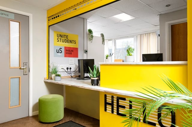 Reception desk computer green ottoman office exterior at Raglan House in Coventry Student Accommodation