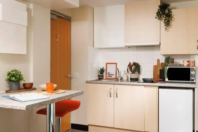 Kitchen with breakfast bar microwave and fridge kitchen at The Tannery Leeds in Leeds Student Accommodation