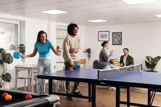 Table tennis and pool players socializing common area at The Tannery Leeds in Leeds Student Accommodation