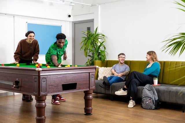 People playing pool on a sofa playing area at The Rackhay in Bristol Student Accommodation