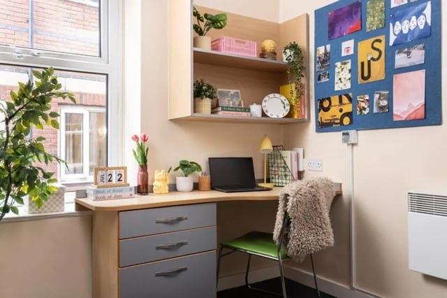 Desk with laptop plants and calendar study area at Lennon Studios in Liverpool Student Accommodation