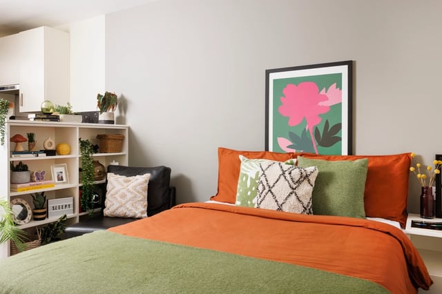 Bed with orange and green bedding and pillows Bedroom at The Old Printworks in Edinburgh Student Accommodation