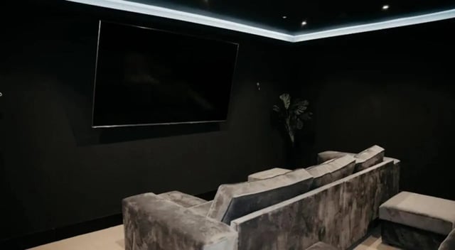 Large screen TV plush sofa and ottoman living room at Volume Works in Birmingham Student Accommodation