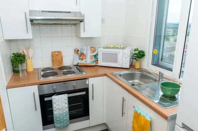 Compact kitchen with oven microwave and sink kitchen at Wardley House in Bradford Student Accommodation