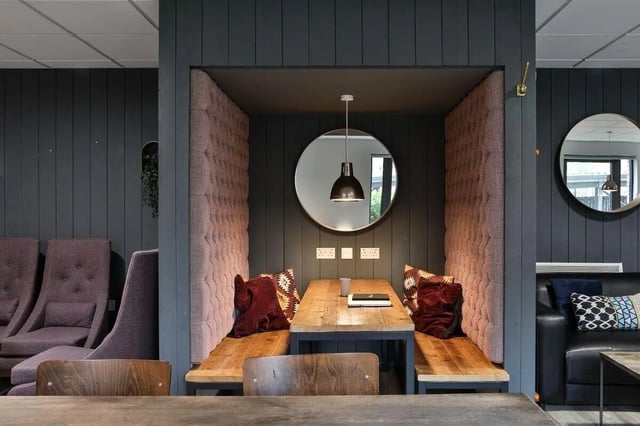 Booth seating with wooden table mirrors and pillows study area at Percy's Place in York Student Accommodation