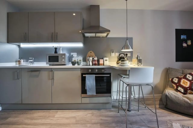 Modern grey kitchen with oven microwave and seating kitchen at Percy's Place in York Student Accommodation