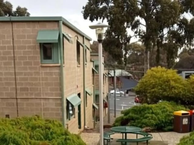 Brick building green awnings picnic table exterior at La Trobe University - Units in Melbourne Student Accommodation
