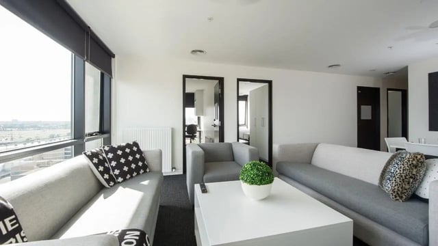 Gray sofas white coffee table plant living room at UniLodge Victoria University in Melbourne Student Accommodation