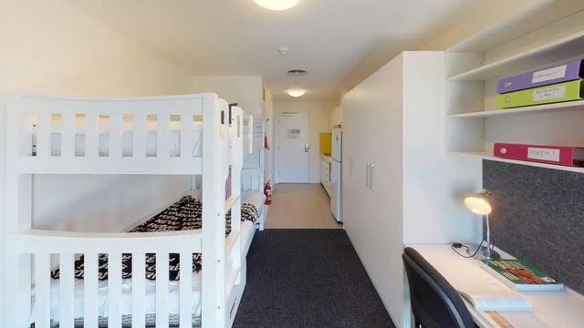 Bunk beds desk cabinets kitchen area living room at UniLodge Victoria University in Melbourne Student Accommodation