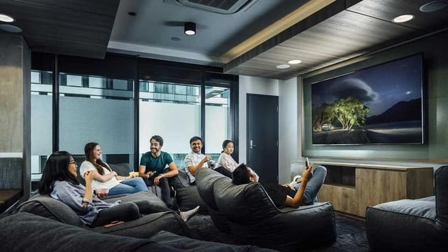 Students relax on beanbags watching TV common room at UniLodge Lincoln House in Melbourne Student Accommodation