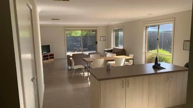 Dining area with tables chairs and kitchen counter living room at La Trobe University Regional Housing - Shepparton in Shepparton Student Accommodation