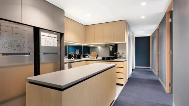 Modern kitchen with island stainless steel fridge and cabinets kitchen at La Trobe University - North and South Apartments in Melbourne Student Accommodation