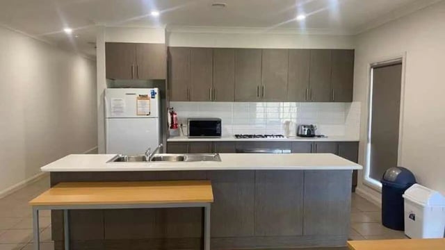 Fridge microwave sink stovetop and cabinets kitchen at La Trobe University Regional Housing - Mildura in Mildura Student Accommodation