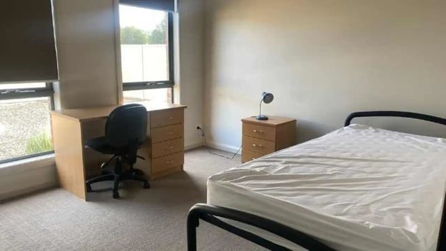 Desk chair bedside lamp and bed bedroom at La Trobe University Regional Housing - Mildura in Mildura Student Accommodation