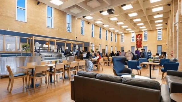 Tables chairs and sofas in a communal area at La Trobe University - Glenn College in Melbourne Student Accommodation