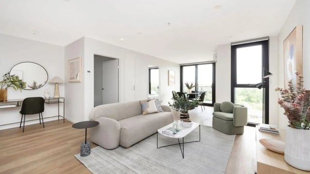 Sofa chair tables mirror desk study area living room at Dickson Village Apartments in Canberra Student Accommodation