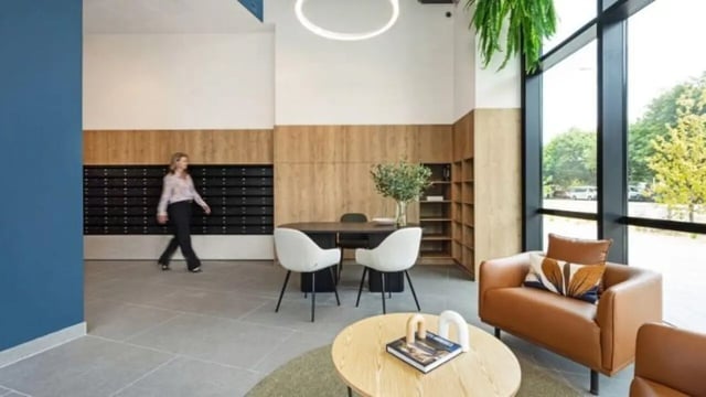 Lobby with mailboxes chairs table sofa living area at Dickson Village Apartments in Canberra Student Accommodation
