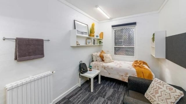 Bed towel radiator shelves bed sofa bedroom at UniLodge @ UC - Campus West & Guginya in Canberra Student Accommodation