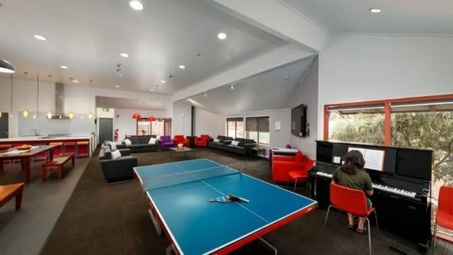 Ping pong table couches piano and kitchen communal room at UniLodge @ UC - Campus West & Guginya in Canberra Student Accommodation