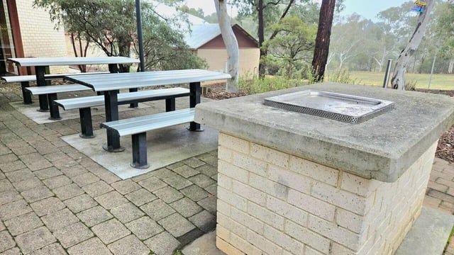 Picnic tables and brick barbecue exterior at UniLodge @ UC - Campus West & Guginya in Canberra Student Accommodation