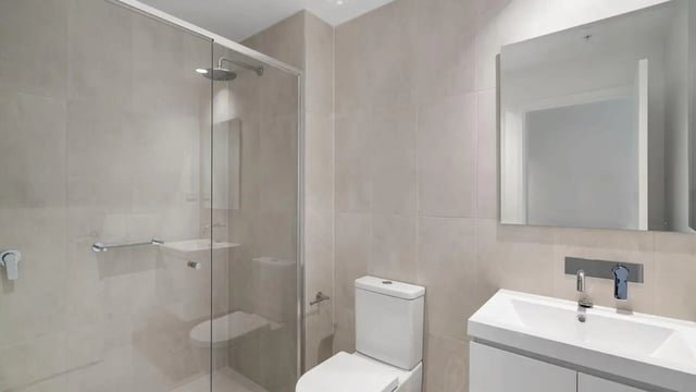 Modern bathroom with shower toilet sink mirror bathroom at Realm Kangaroo Point in Brisbane Student Accommodation