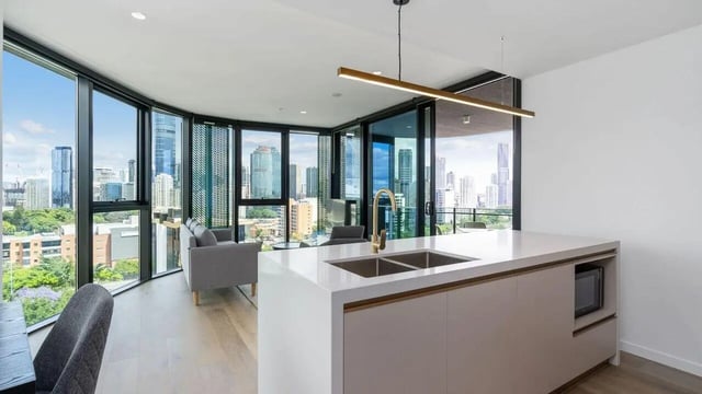 Modern kitchen island sink sofa with city view living room at Realm Kangaroo Point in Brisbane Student Accommodation