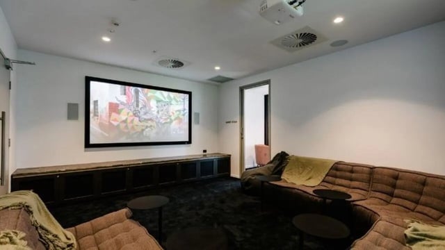 Large screen projector comfortable seating entertainment room at Realm Kangaroo Point in Brisbane Student Accommodation