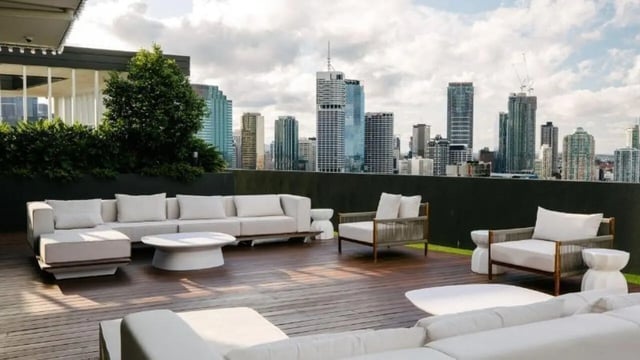 Outdoor seating with cityscape view living room at Realm Kangaroo Point in Brisbane Student Accommodation