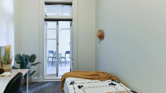 Bed desk plants and outdoor seating bedroom at UniLodge Herston in Brisbane Student Accommodation