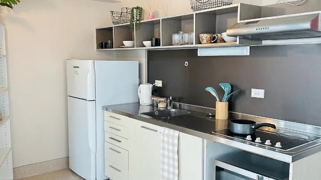 Refrigerator sink stove microwave kitchen at Wellesley Apartments in Auckland Student Accommodation