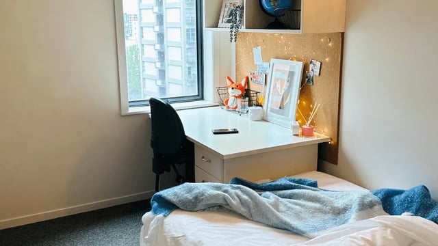 Desk with chair and bed bedroom study area at Wellesley Apartments in Auckland Student Accommodation