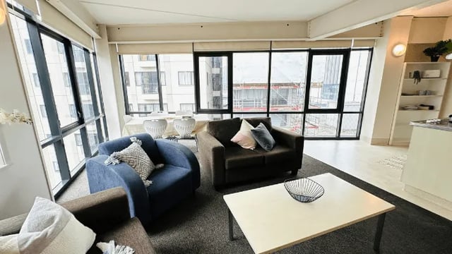 Two sofas coffee table large windows living room at Wellesley Apartments in Auckland Student Accommodation