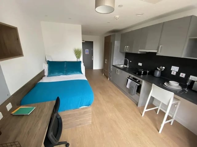 Bed desk kitchen area with modern cabinets studio apartment at The Oaks in Coventry Student Accommodation