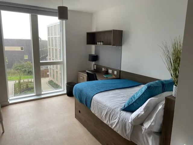 Bed desk chair bin and window bedroom at The Oaks in Coventry Student Accommodation