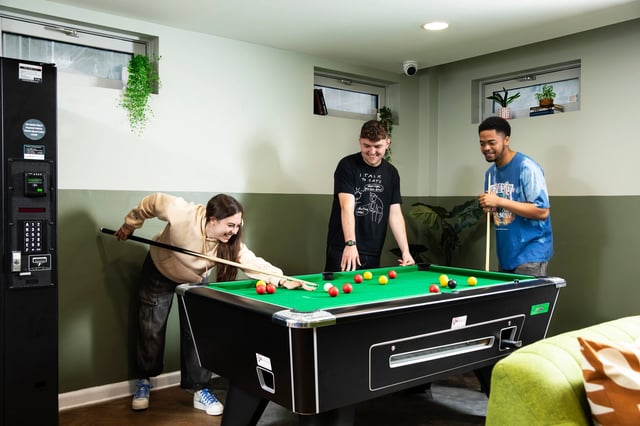 Students playing pool in a recreation room playing area at Beaumont Court in London Student Accommodation