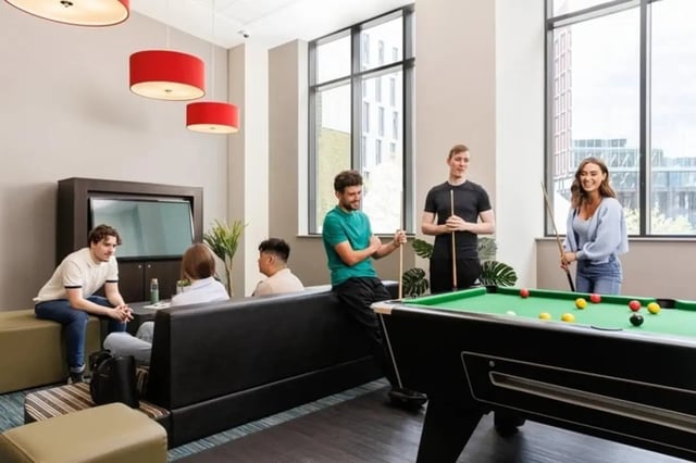 Students playing pool with seating area living room at Wellington St Plaza in Newcastle Upon Tyne Student Accommodation