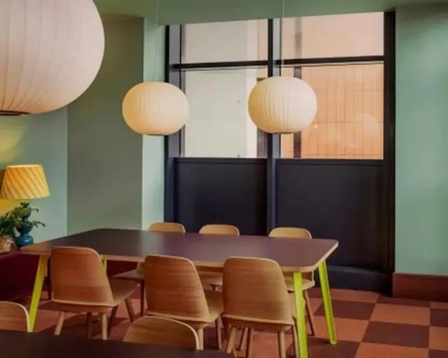 Dining table with chairs and pendant lights dining area at Scape Hammersmith in London Student Accommodation