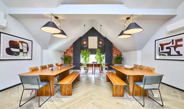 Two long wooden tables with benches and chairs dining area at Frederick House in York Student Accommodation