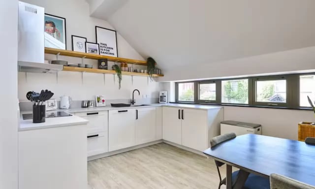 White kitchen cabinets with wooden shelves kitchen. at Frederick House in York Student Accommodation