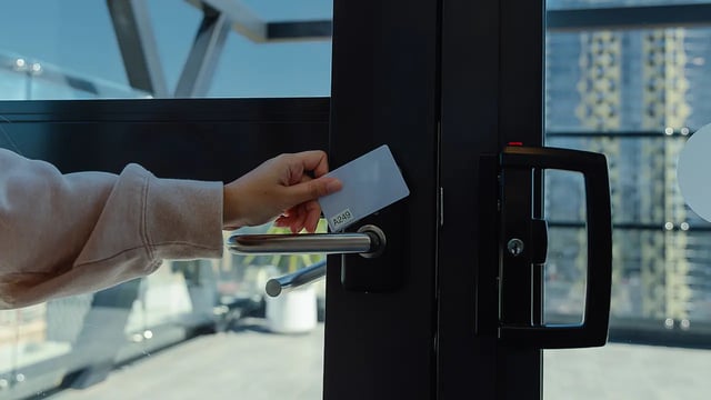 Hand swiping keycard at modern door lock Exterior at dwell East End Adelaide in Adelaide Student Accommodation