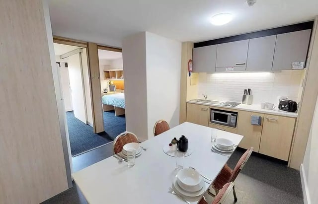 Dining table kitchen and bedroom interior at dwell Village Melbourne City in Melbourne Student Accommodation