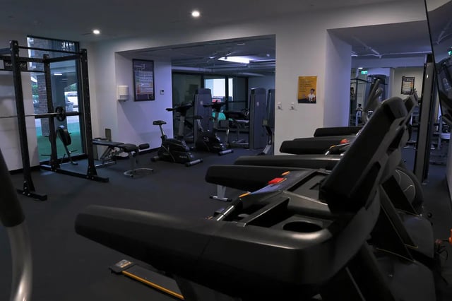 Treadmills exercise bikes weight rack gym area at dwell Village Melbourne City in Melbourne Student Accommodation