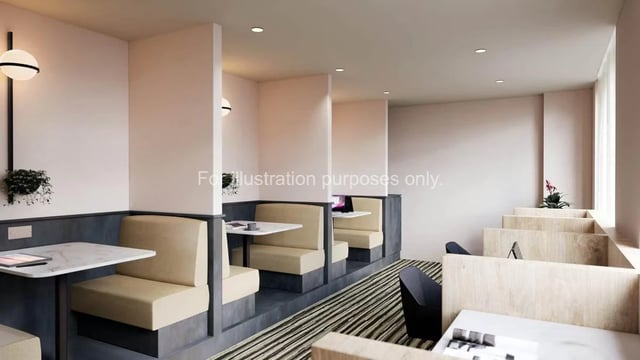 Booth seating with tables and laptops communal area at The Fabric Works in Leeds Student Accommodation